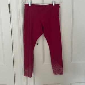 Women’s red Lululemon leggings with reflective end